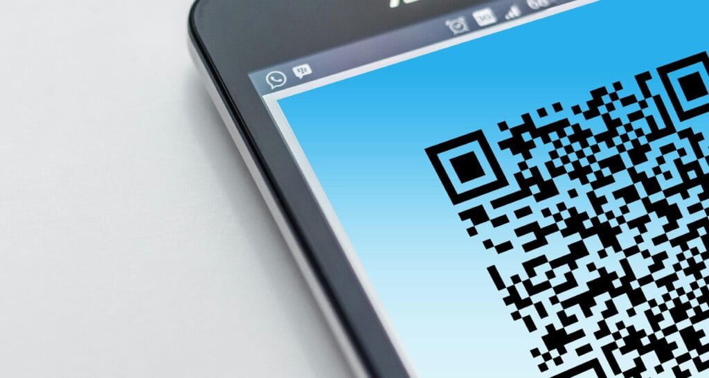 pexels-photo-278430-278430 High-resolution close-up of a smartphone displaying a QR code on its screen.